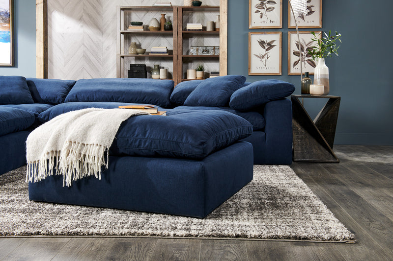 Sofa sectionnel modulaire Eclipse 4 pièces en tissu d’apparence lin avec pouf et coussins réversibles en duvet et plumes - bleu marine